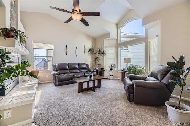 living room with ceiling fan, carpet flooring, and high vaulted ceiling