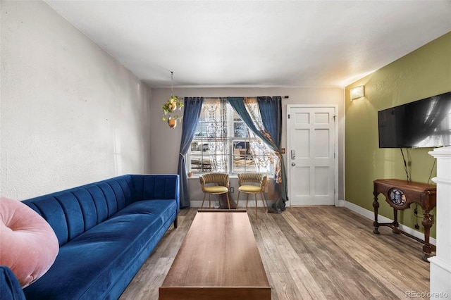 living room with baseboards and wood finished floors