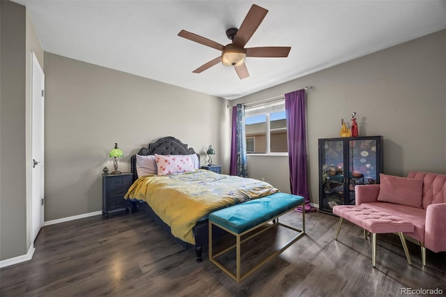 bedroom featuring ceiling fan, baseboards, and wood finished floors