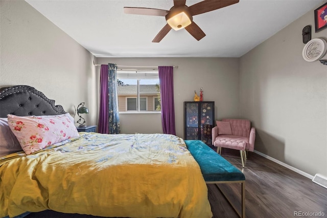 bedroom featuring visible vents, wood finished floors, a ceiling fan, and baseboards