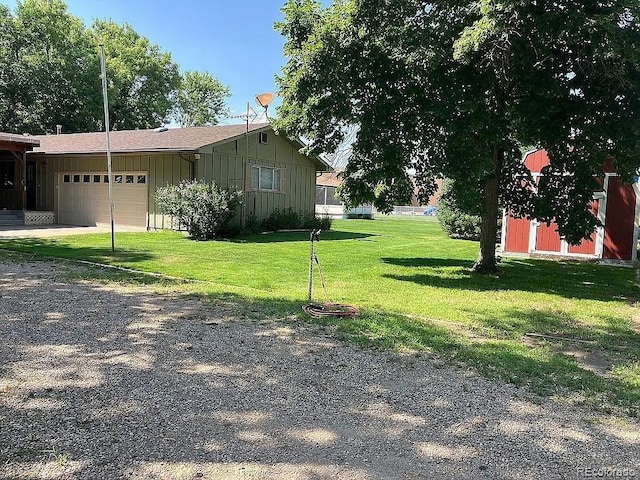 view of side of property with a garage and a lawn