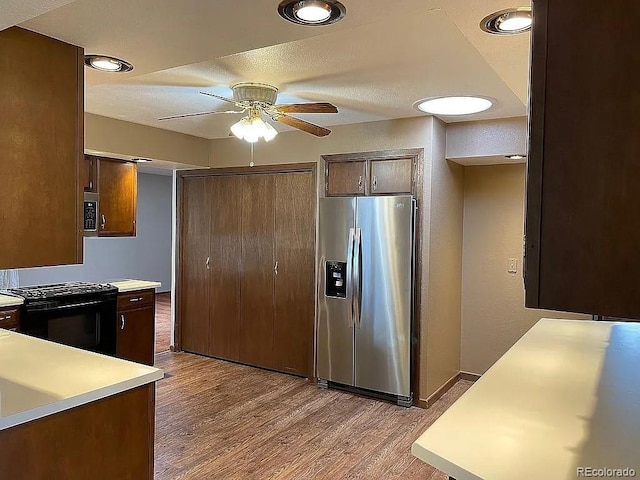 kitchen featuring light hardwood / wood-style flooring, ceiling fan, and appliances with stainless steel finishes