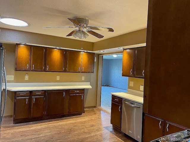 kitchen with dark brown cabinetry, stainless steel dishwasher, light hardwood / wood-style floors, and ceiling fan