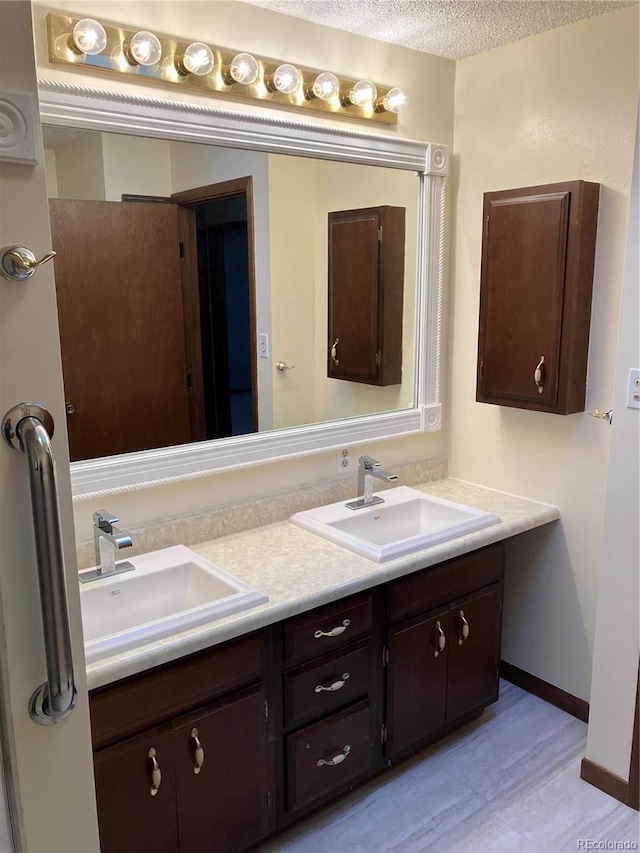 bathroom featuring vanity and a textured ceiling