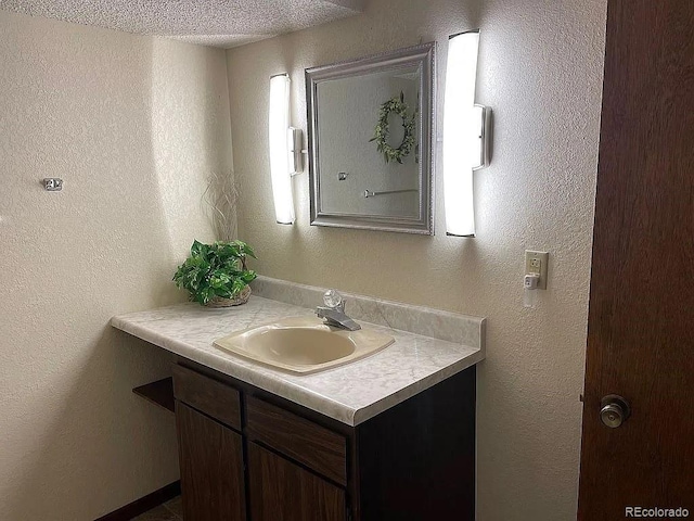 bathroom featuring vanity and a textured ceiling