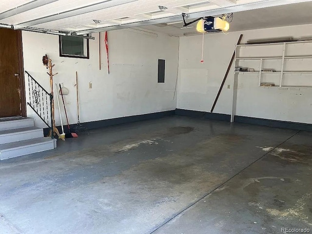 garage with a garage door opener and electric panel