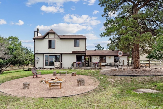 rear view of property with a lawn and a patio area