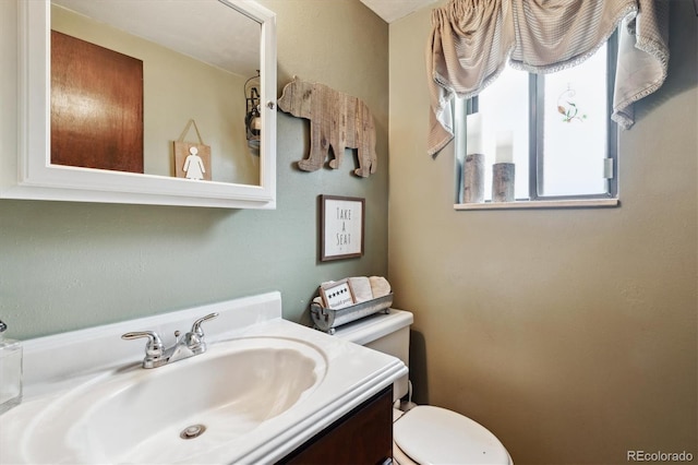 bathroom featuring toilet and vanity