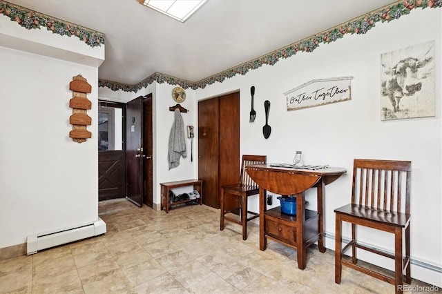 dining room featuring light tile patterned floors and a baseboard heating unit