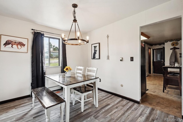 tiled dining room featuring an inviting chandelier and baseboard heating