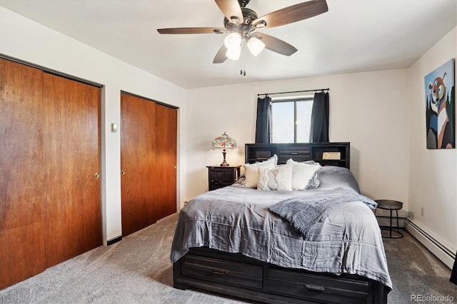 carpeted bedroom with ceiling fan and multiple closets