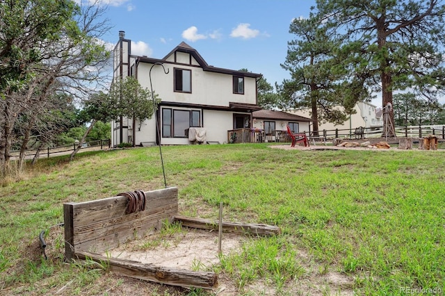 back of property with a lawn