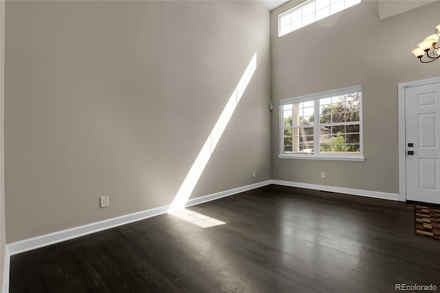 11565 Crow Hill Dr, Parker, CO 80134 - entrance foyer featuring dark wood finished floors, a chandelier, and a high ceiling