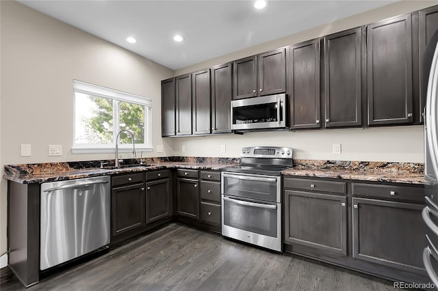 11565 Crow Hill Dr, Parker, CO 80134 - kitchen with stainless steel appliances, dark wood-style flooring, dark stone countertops, and recessed lighting