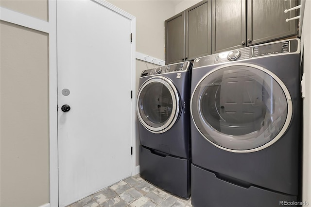 11565 Crow Hill Dr, Parker, CO 80134 - laundry room with cabinet space, washing machine and clothes dryer, and stone finish floors