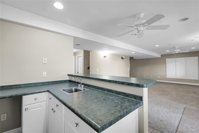 11565 Crow Hill Dr, Parker, CO 80134 - kitchen with a peninsula, dark countertops, a ceiling fan, light carpet, and recessed lighting
