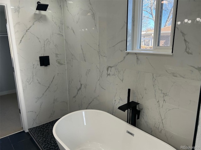 bathroom featuring tile patterned flooring and a bathing tub