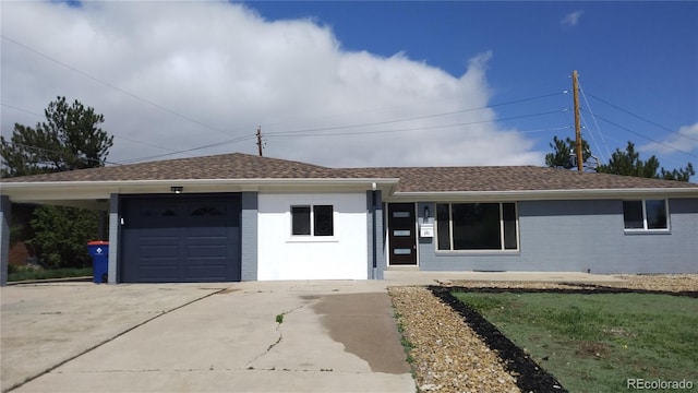 single story home featuring roof with shingles, driveway, and brick siding