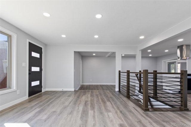 entrance foyer featuring baseboards, recessed lighting, and wood finished floors