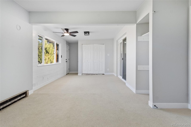 unfurnished bedroom with baseboards, a baseboard radiator, and carpet