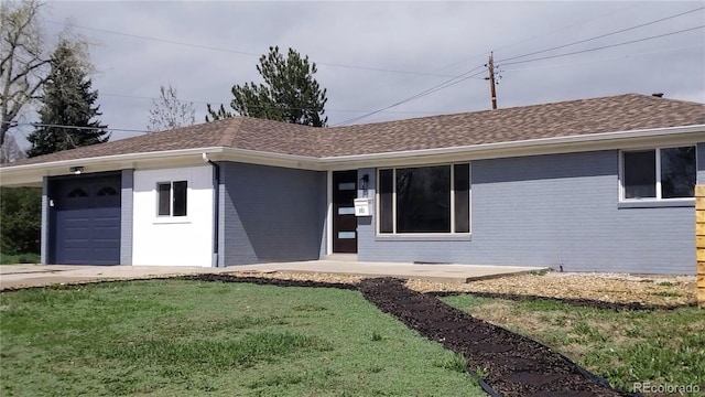 951 E 10th Ave, Broomfield, CO 80020 - view of front facade with a front yard, brick siding, and a shingled roof