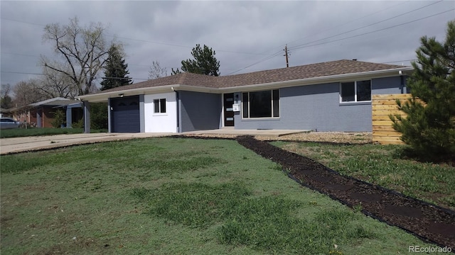 951 E 10th Ave, Broomfield, CO 80020 - single story home with an attached garage, a front lawn, brick siding, and driveway