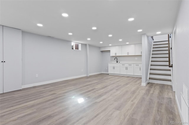 951 E 10th Ave, Broomfield, CO 80020 - basement featuring a sink, light wood-type flooring, baseboards, stairs, and recessed lighting
