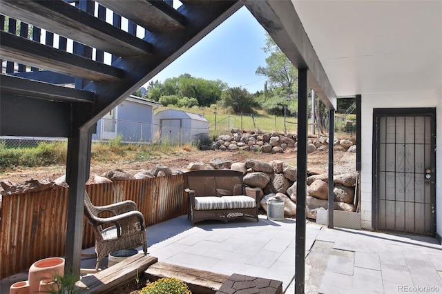 view of patio with a pergola and fence