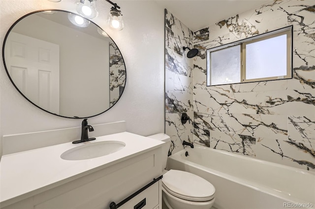 full bathroom with vanity, tiled shower / bath combo, and toilet