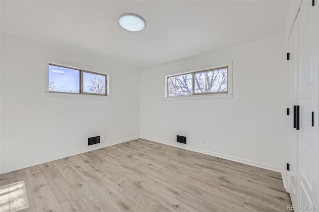 spare room featuring light wood-type flooring