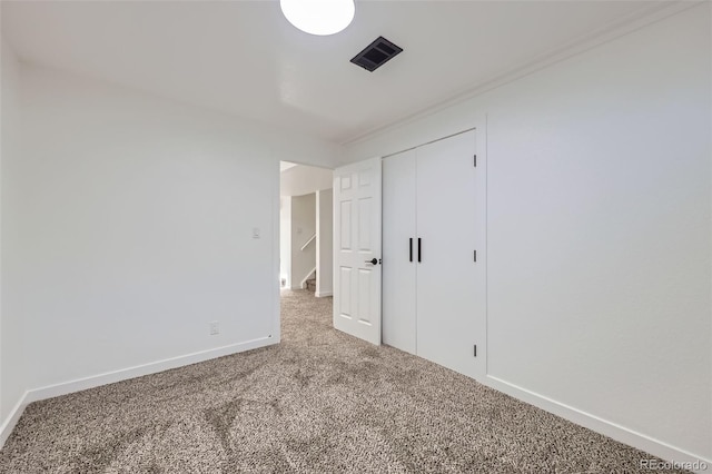 unfurnished bedroom with carpet and a closet