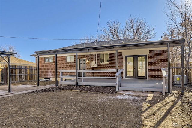 rear view of property featuring french doors, a porch, and cooling unit