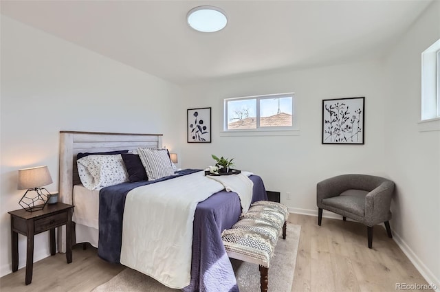 bedroom with light wood-style floors and baseboards