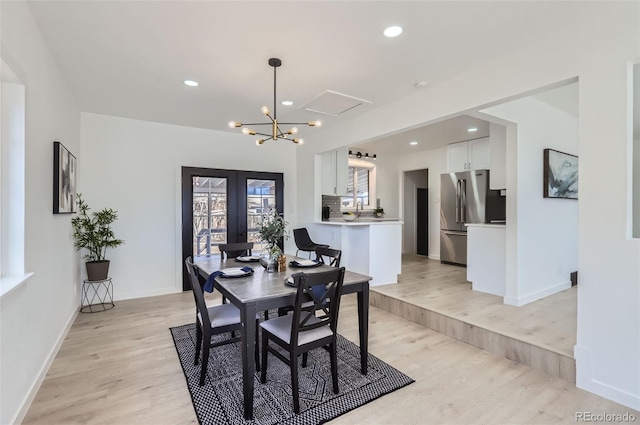 dining space featuring recessed lighting, french doors, light wood-style flooring, and baseboards