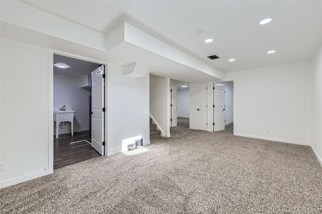 interior space with visible vents, stairway, dark colored carpet, and recessed lighting