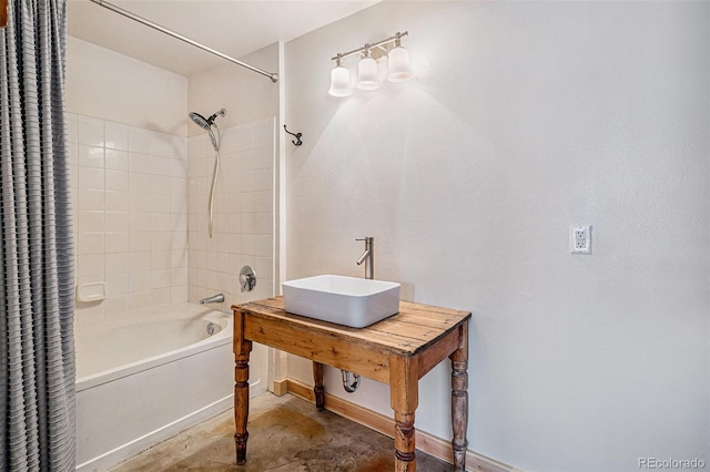 bathroom featuring sink, concrete floors, and shower / bathtub combination with curtain