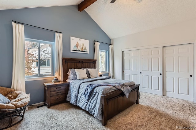 bedroom featuring a ceiling fan, lofted ceiling with beams, light carpet, and a closet
