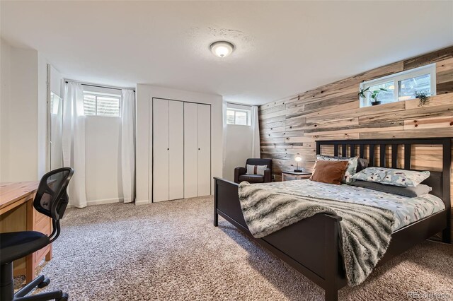 carpeted bedroom with wooden walls
