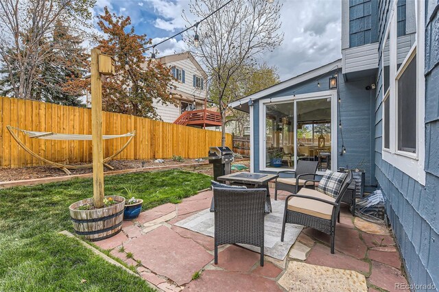 view of patio featuring a fenced backyard, an outdoor hangout area, and grilling area
