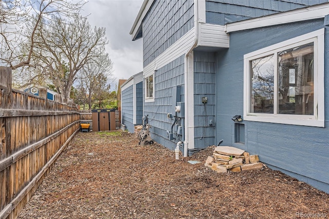 view of side of home featuring fence