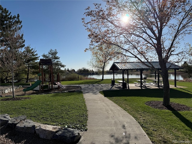 view of community featuring a lawn, a water view, a gazebo, and playground community
