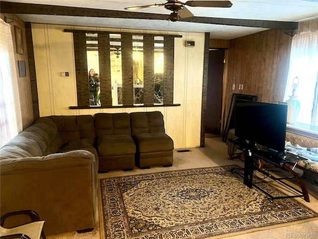 living room featuring ceiling fan and wooden walls