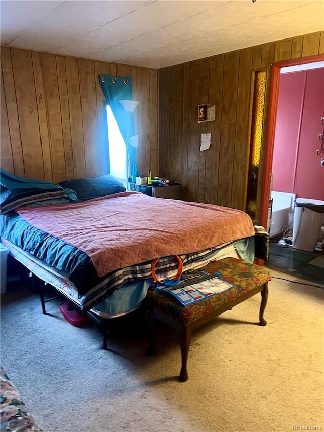 carpeted bedroom featuring wood walls