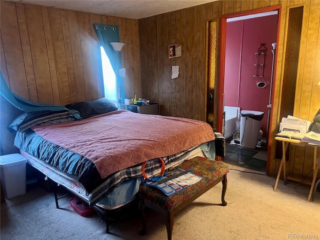 carpeted bedroom with wood walls