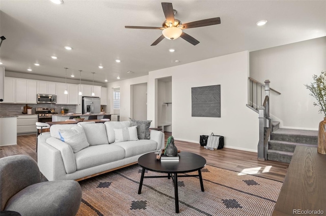 living area with ceiling fan, recessed lighting, wood finished floors, and baseboards
