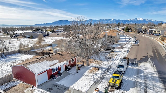 snowy aerial view featuring a mountain view