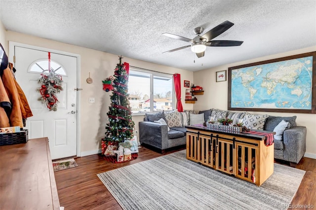 living room featuring a textured ceiling, dark hardwood / wood-style floors, and ceiling fan