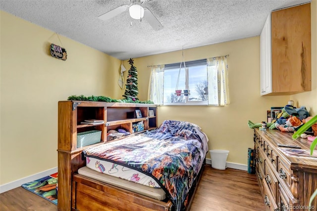 bedroom featuring ceiling fan, light hardwood / wood-style flooring, and a textured ceiling