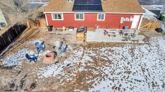 snow covered rear of property featuring a patio area