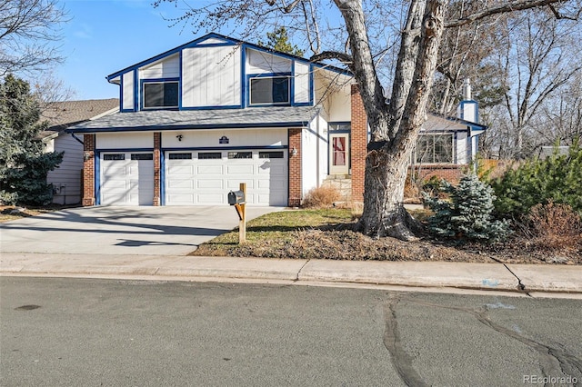 traditional-style house featuring a garage, brick siding, and concrete driveway